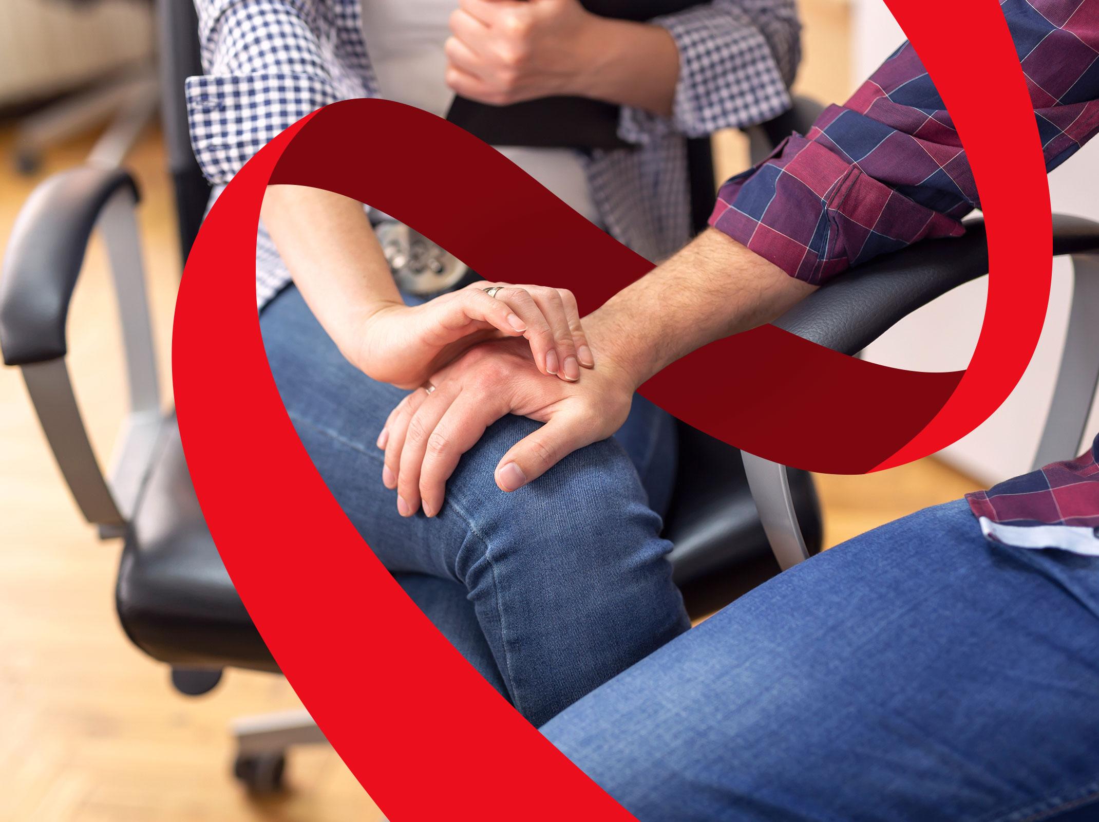 A business person putting a hand on another person's knee.  The other person is rejecting the advance.  They are in a business setting.