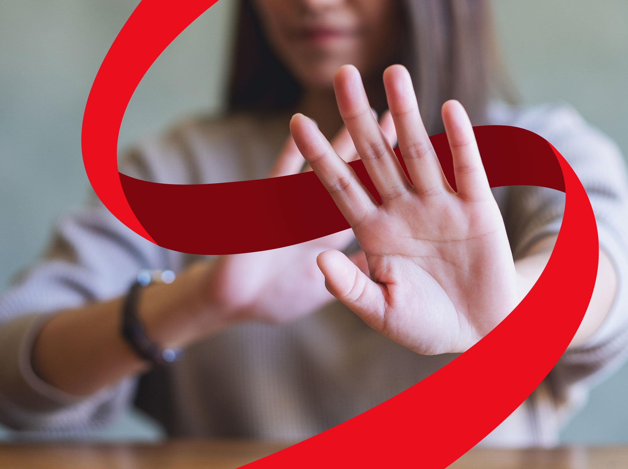 A business professional is holding up both hands in a "stop" signal.