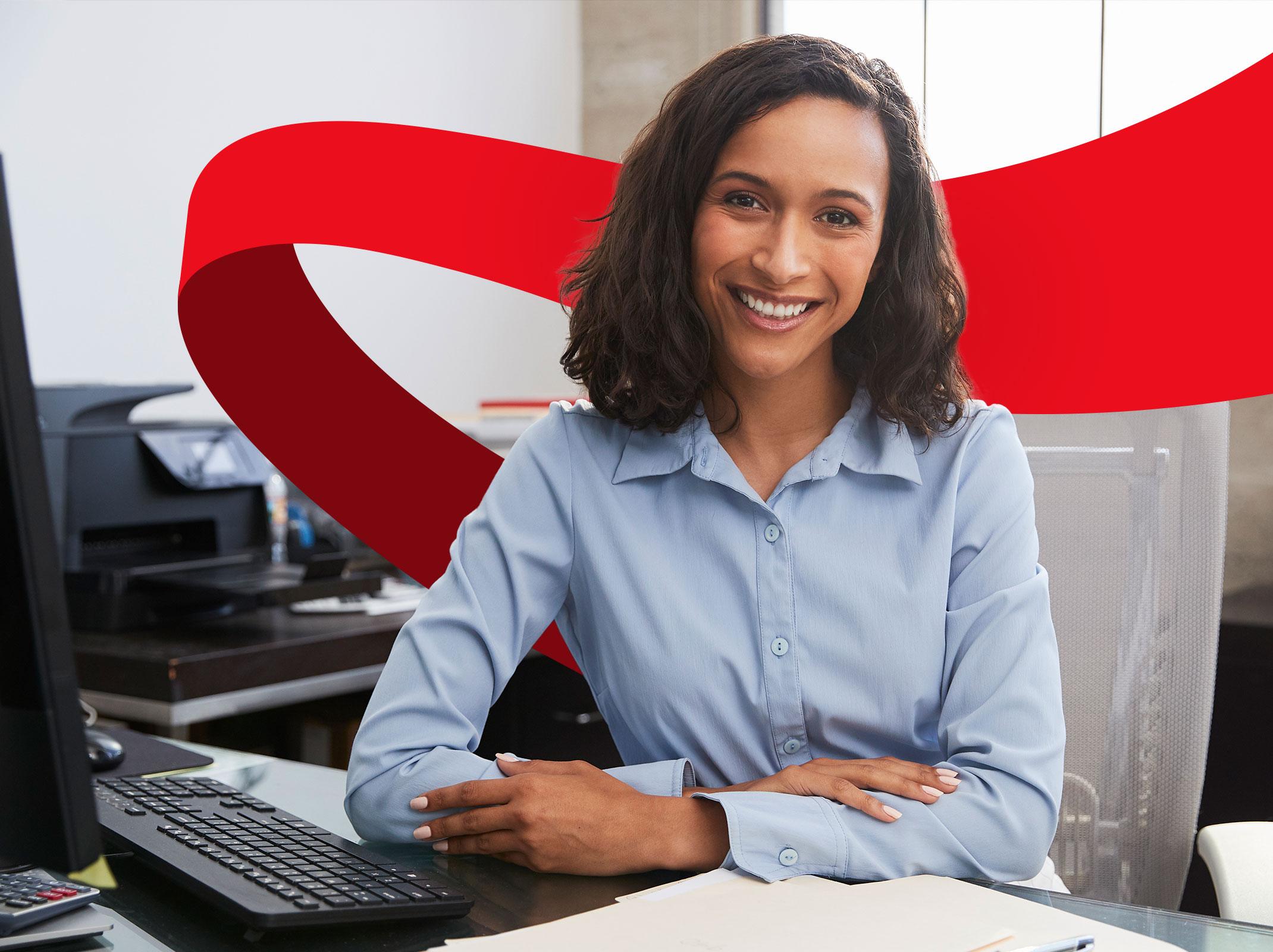 Professional woman seated at desk smiling