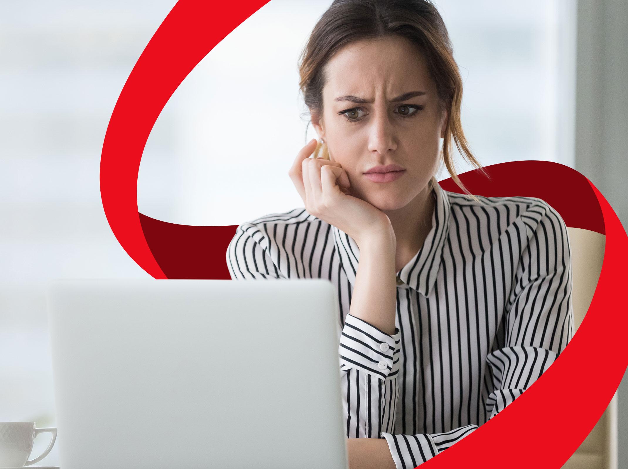 Woman reads email, looks confused