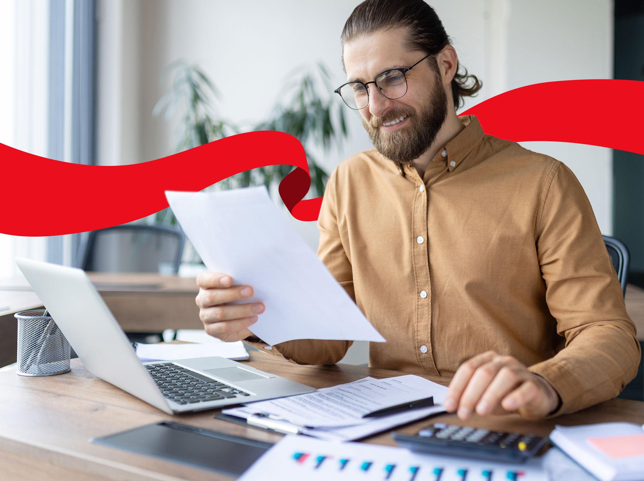 Male accountant looking for accounting paperwork in his office