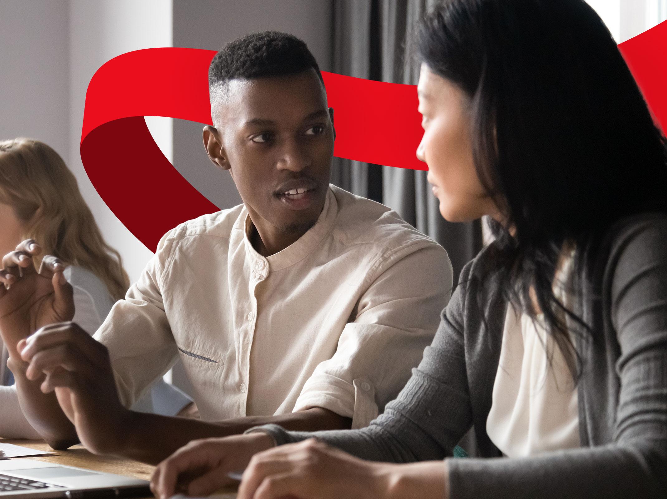 Business professionals having an emotional conversation in an office setting.