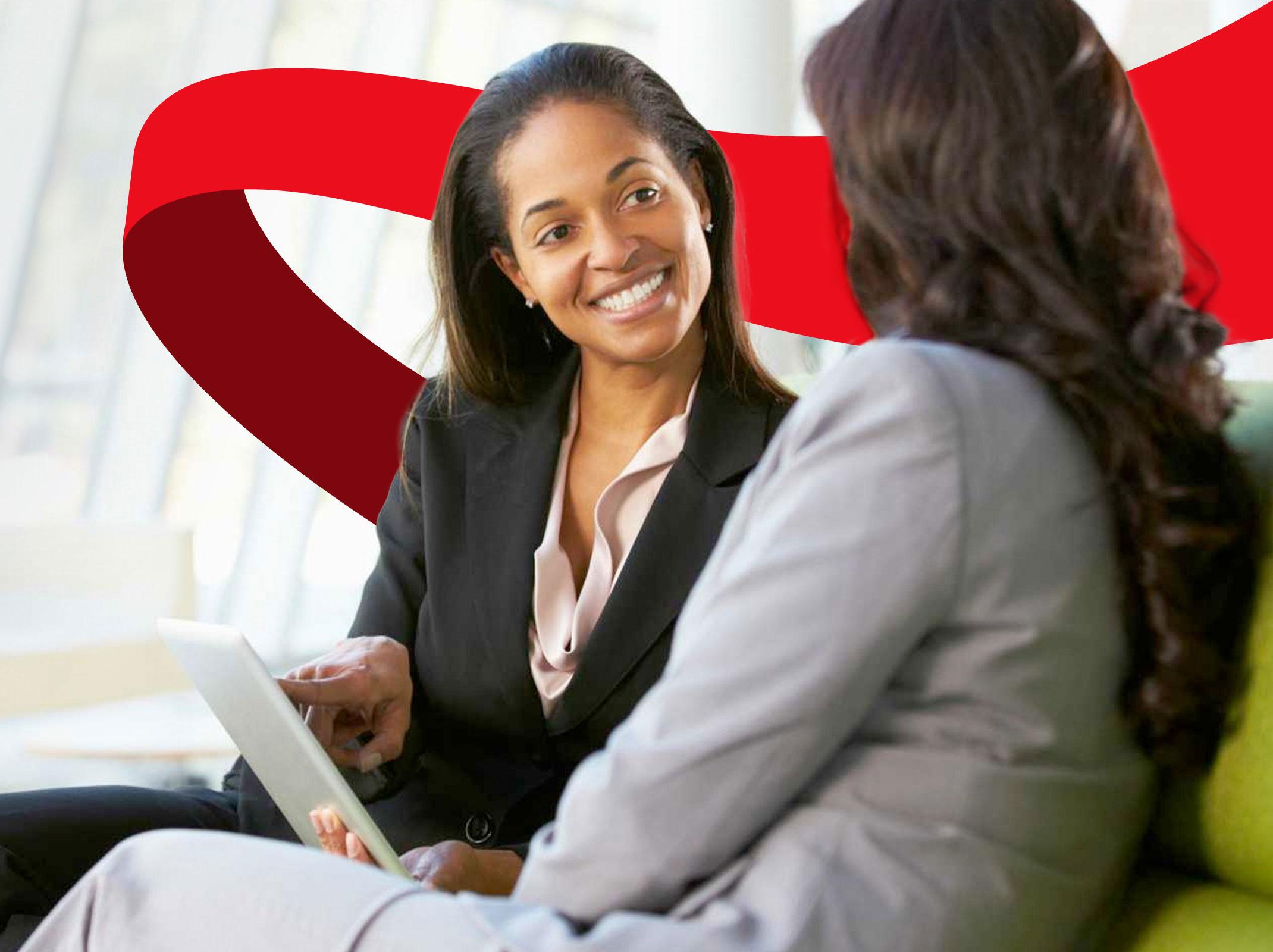 A manager coaching and mentoring an employee in an office setting.