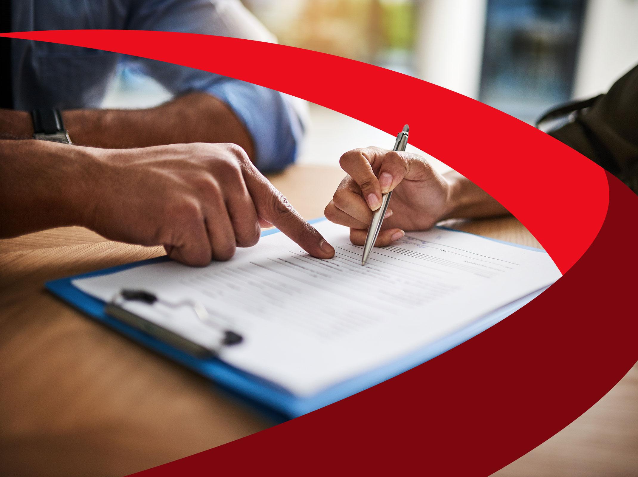 Two business professionals reviewing a document in an office setting.
